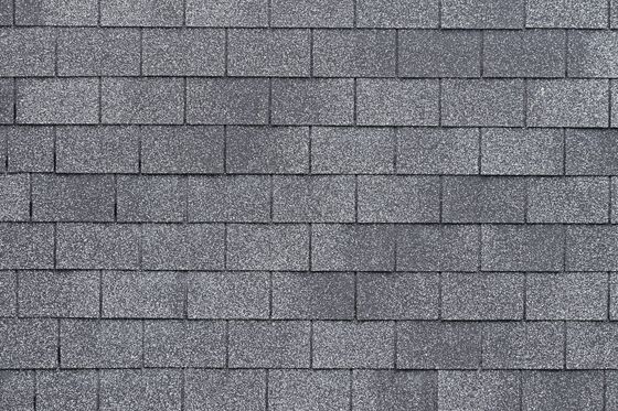 Close-up of a gray, textured asphalt roof shingle pattern.