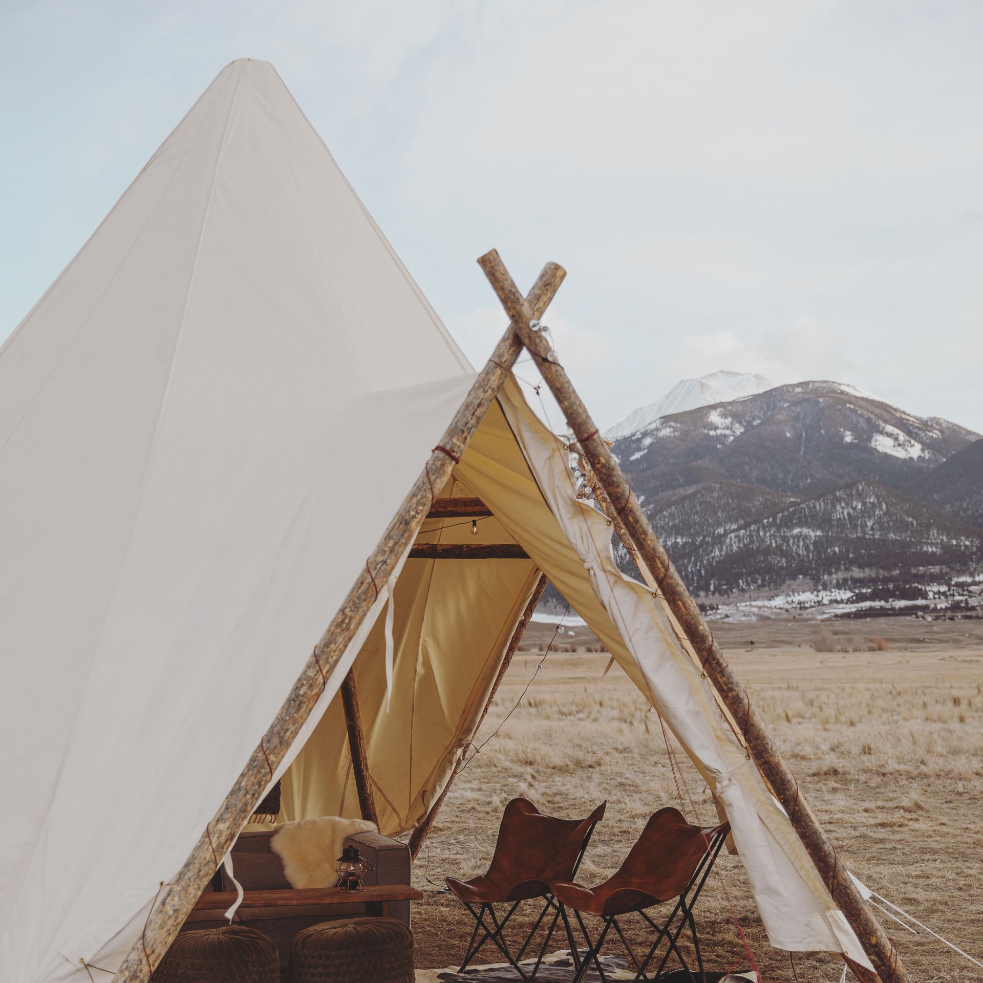 A white tent with a mountain in the background