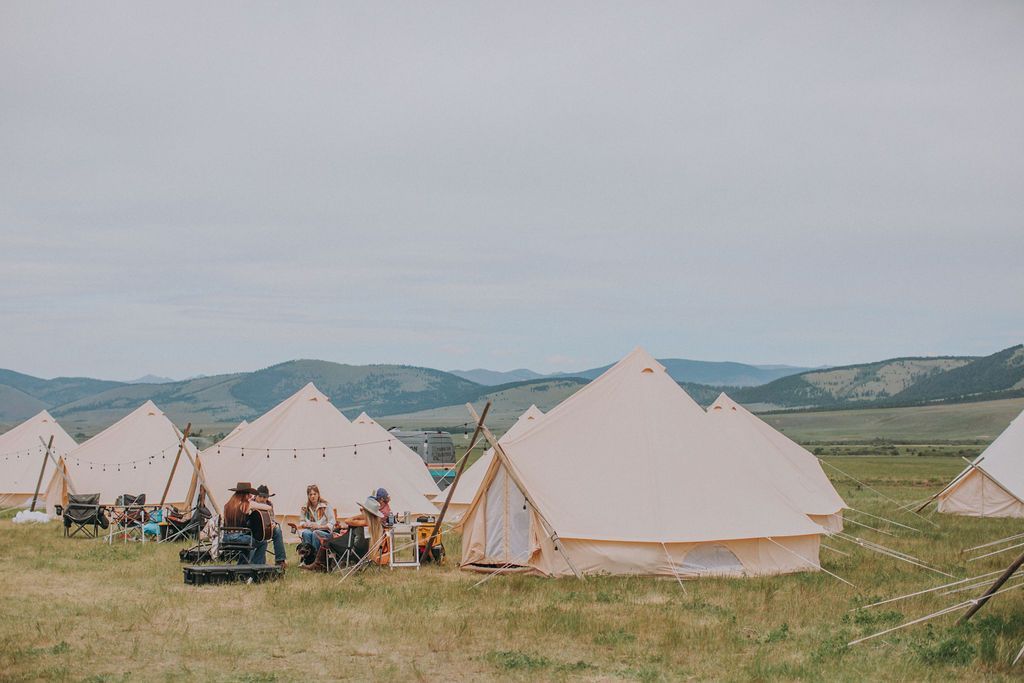 A group of tents are sitting in a field.