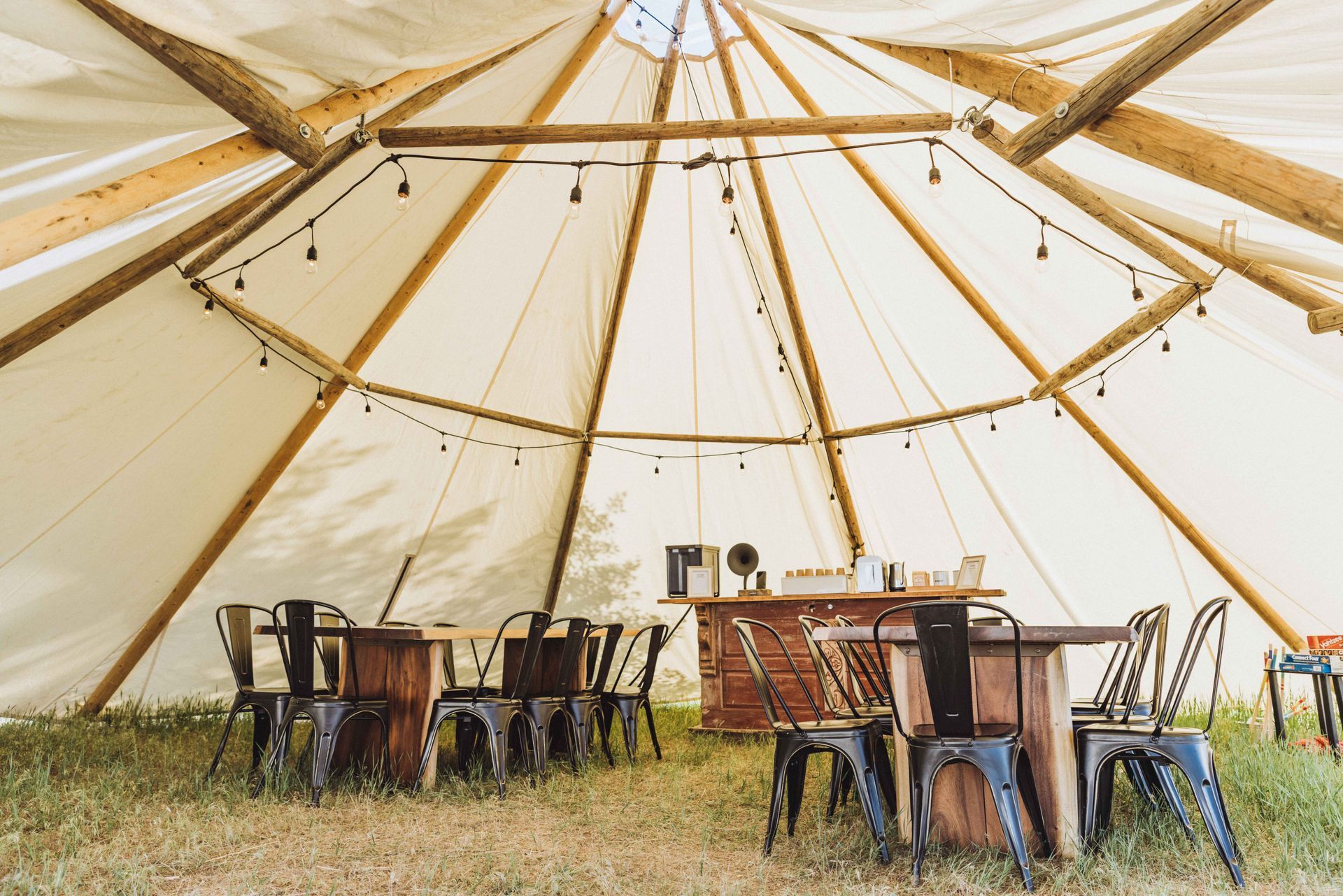A large tent with tables and chairs inside of it.