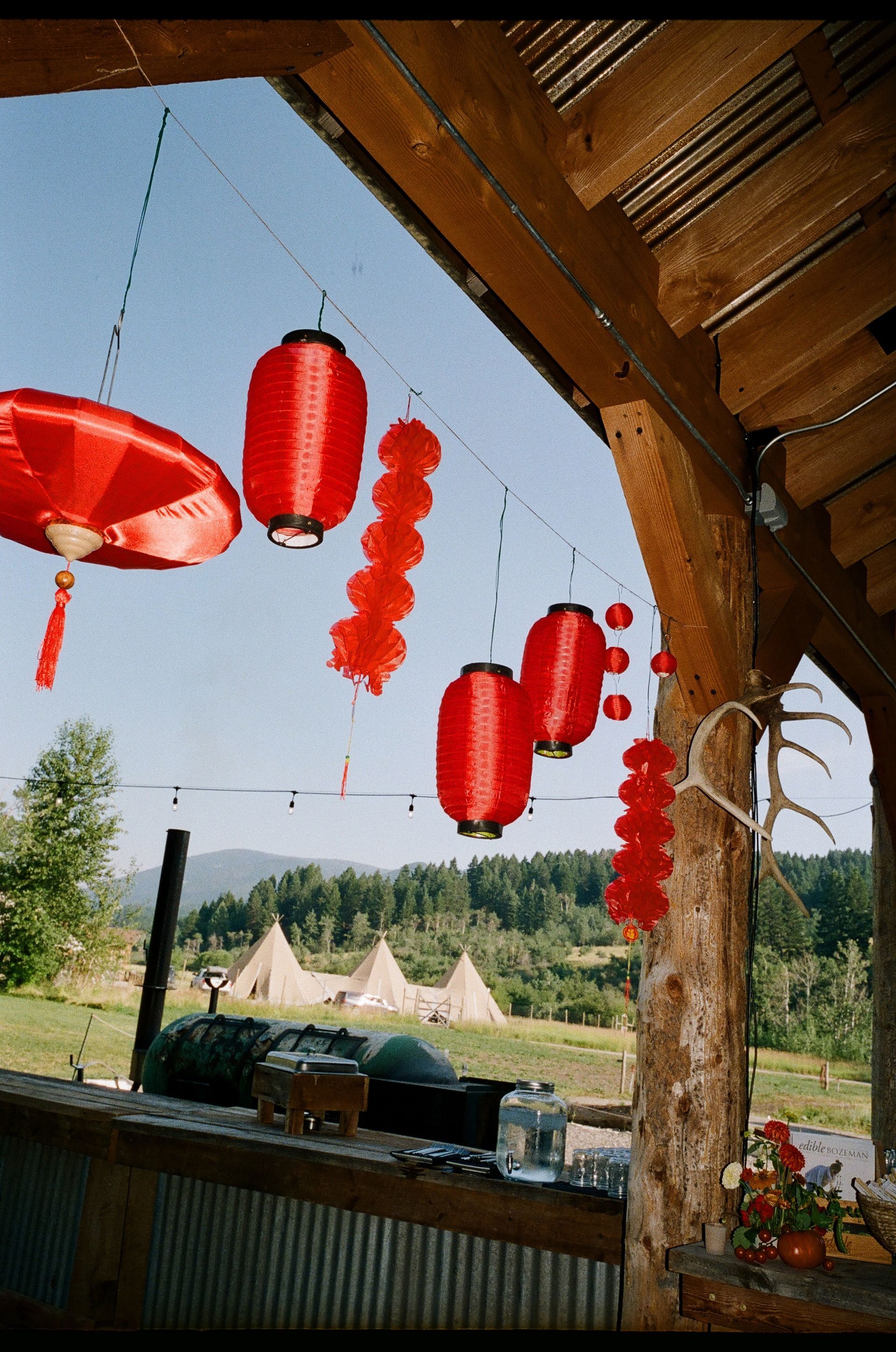 A bunch of red lanterns hanging from a roof