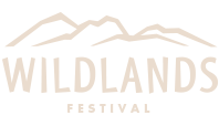 A logo for wildlands festival with a mountain in the background.
