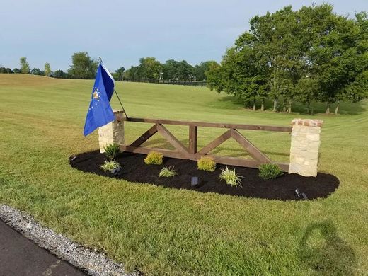 A wooden gate with a blue flag hanging from it