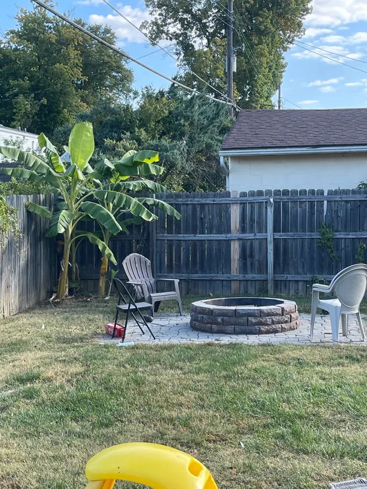 There is a fire pit in the middle of the backyard.