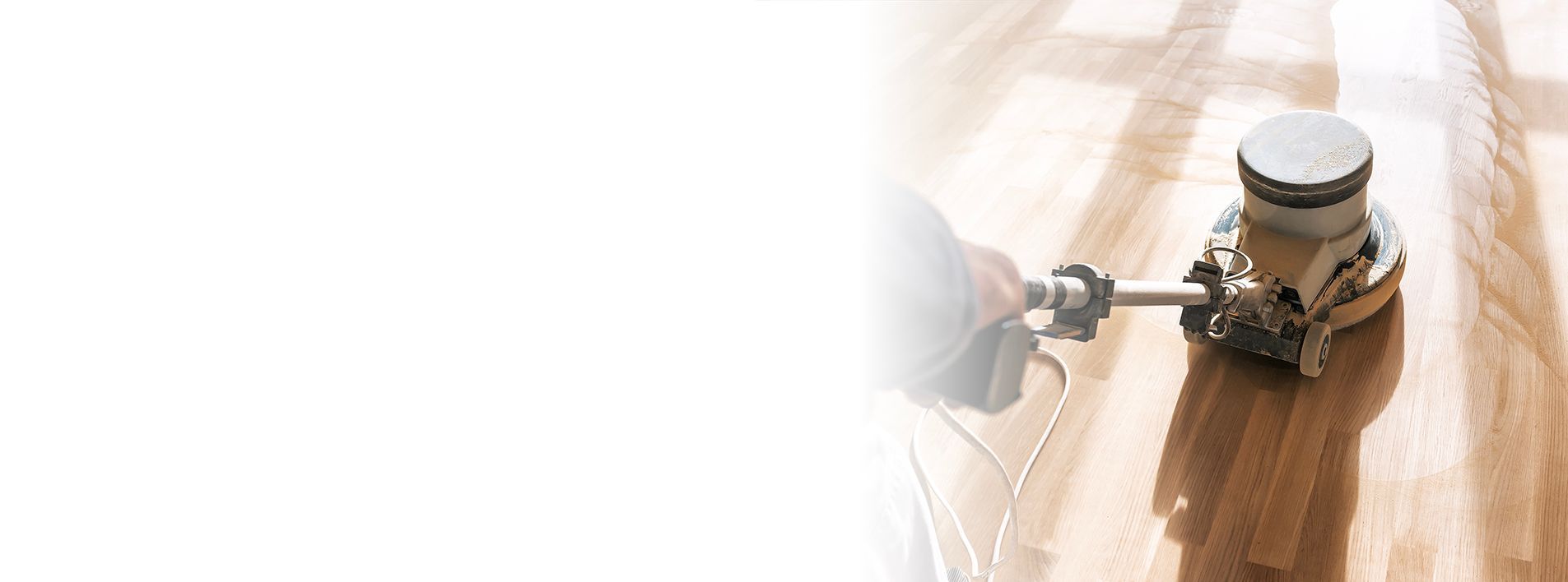Floor sander refinishing a wooden floor.