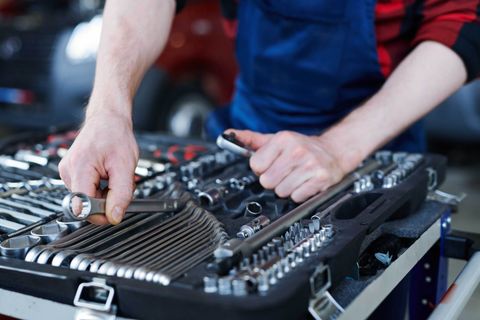 Mechanic Picking up Spanner — Car Repairs in Cardiff, NSW