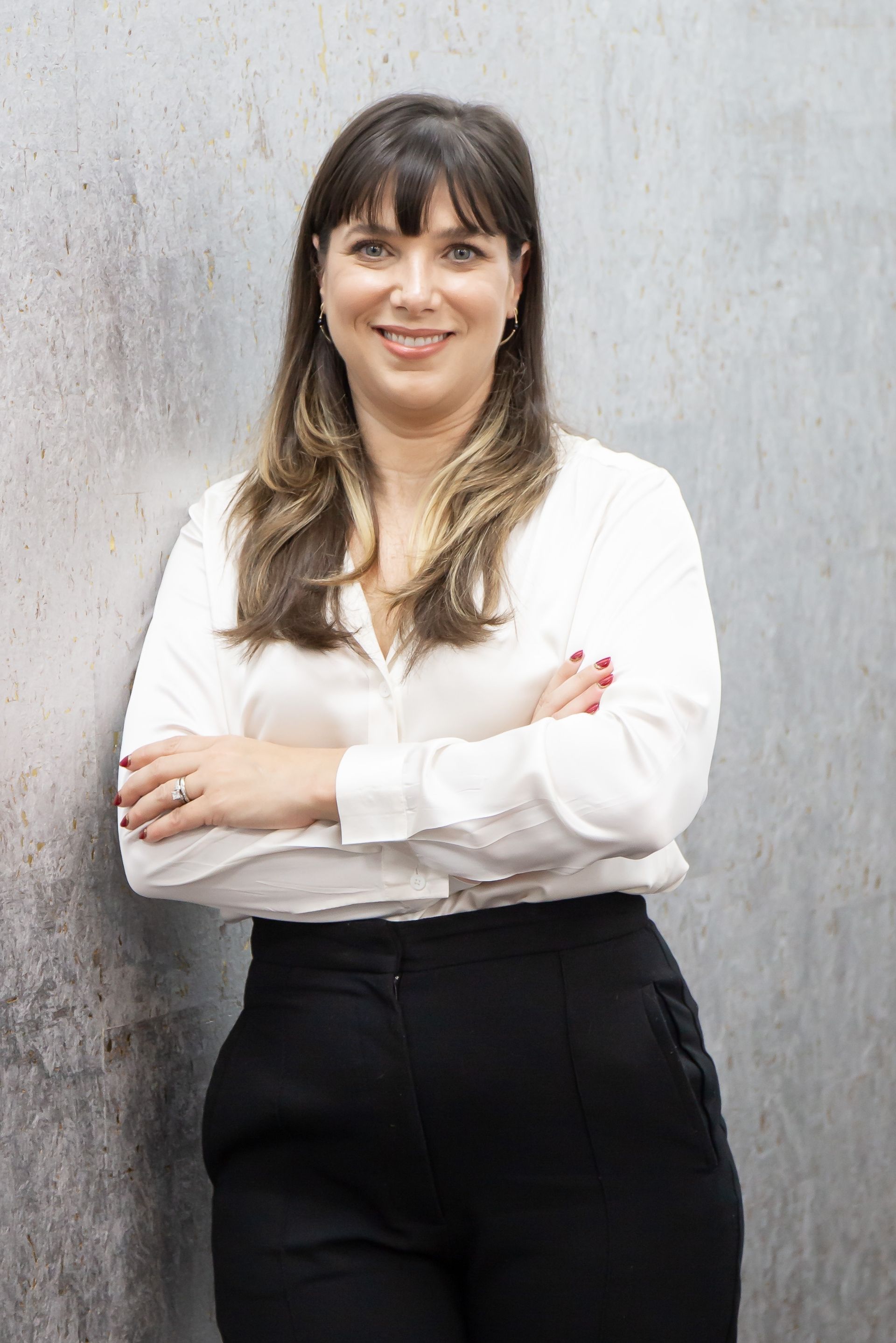 Stephanie Gibson — Woman wearing white top and black skirt. 