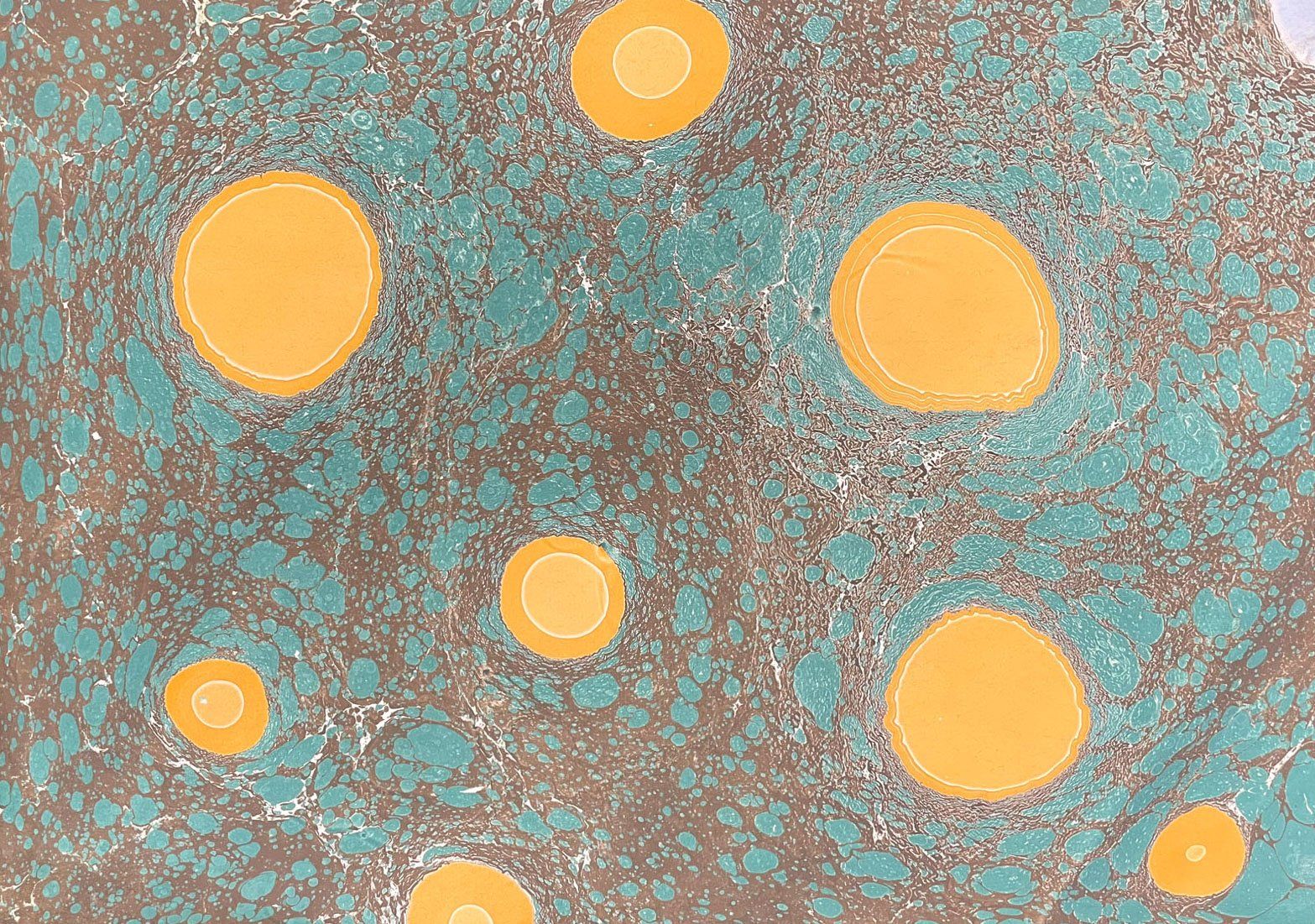 A very refined look with controlled use of oranges, greens, and neutrals with a stone marbled pattern.