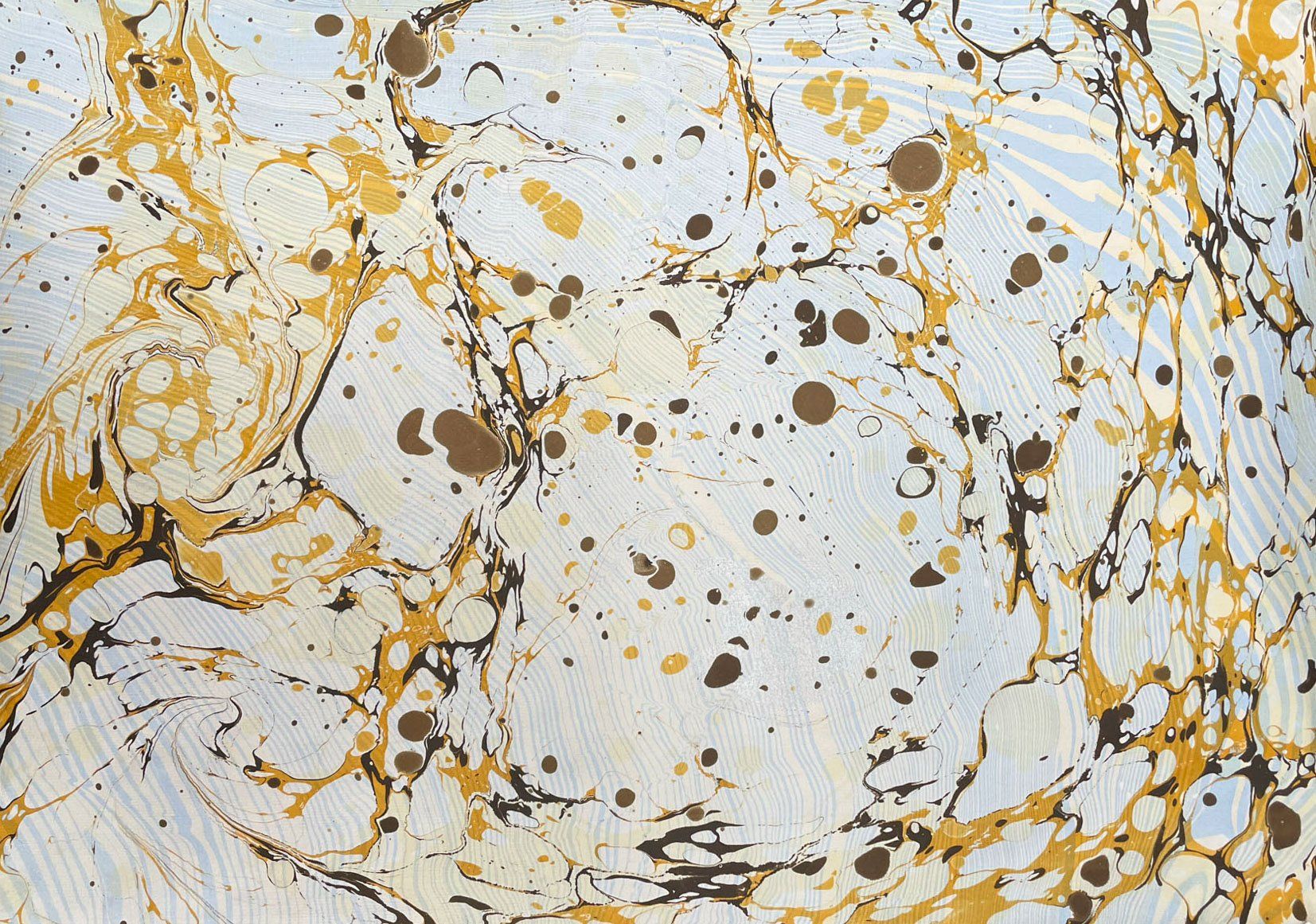 Layered design of marbled paper in blue and gold