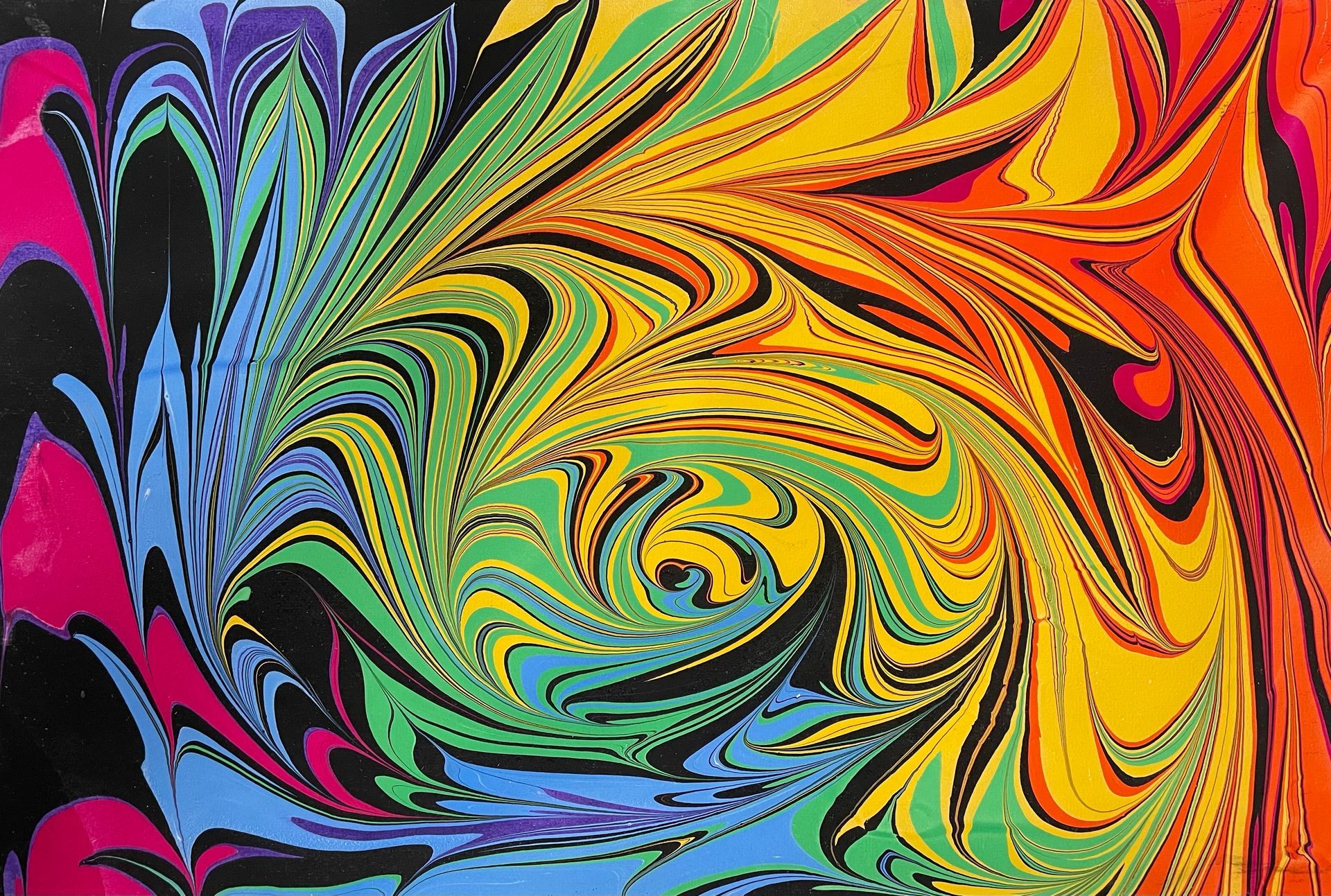 Rainbow spiraling colors in a marbled artwork.