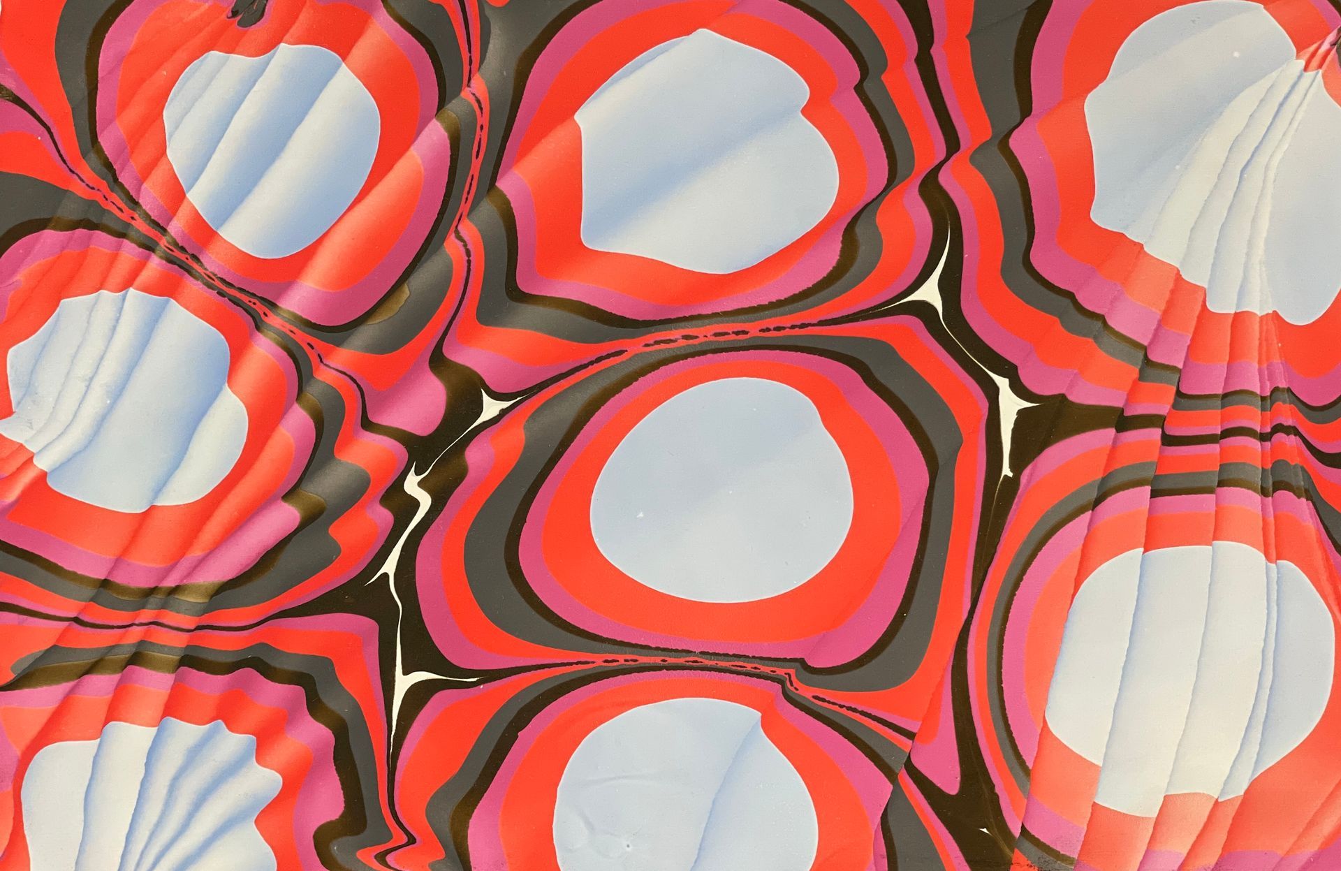 Red and silver rippling colors in a marbled artwork.