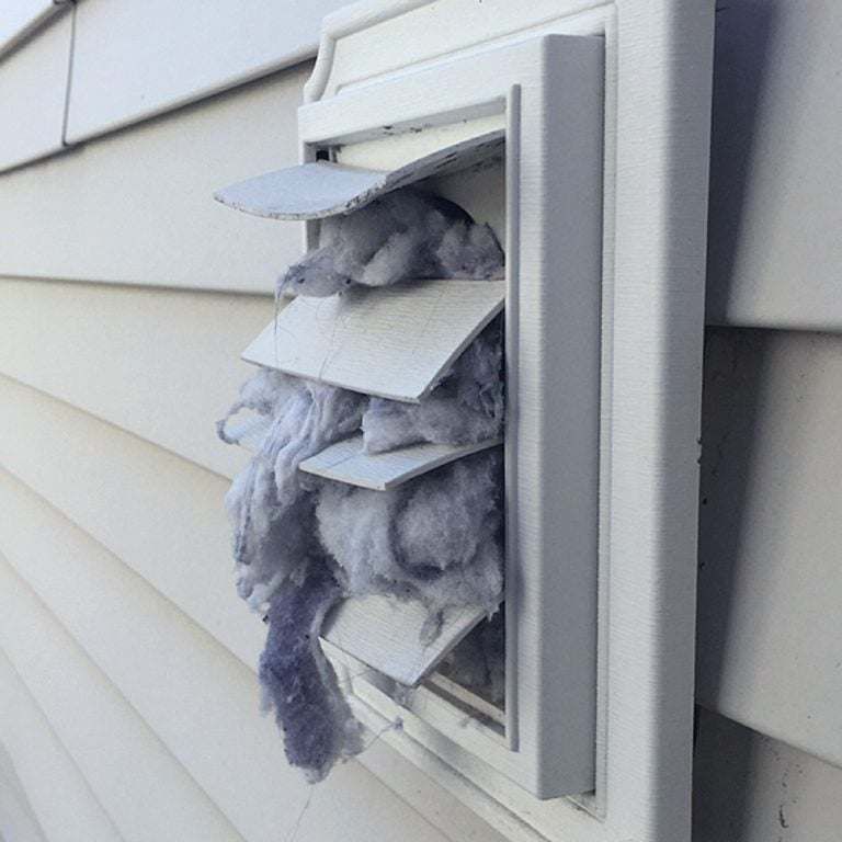 A dirty vent on the side of a house