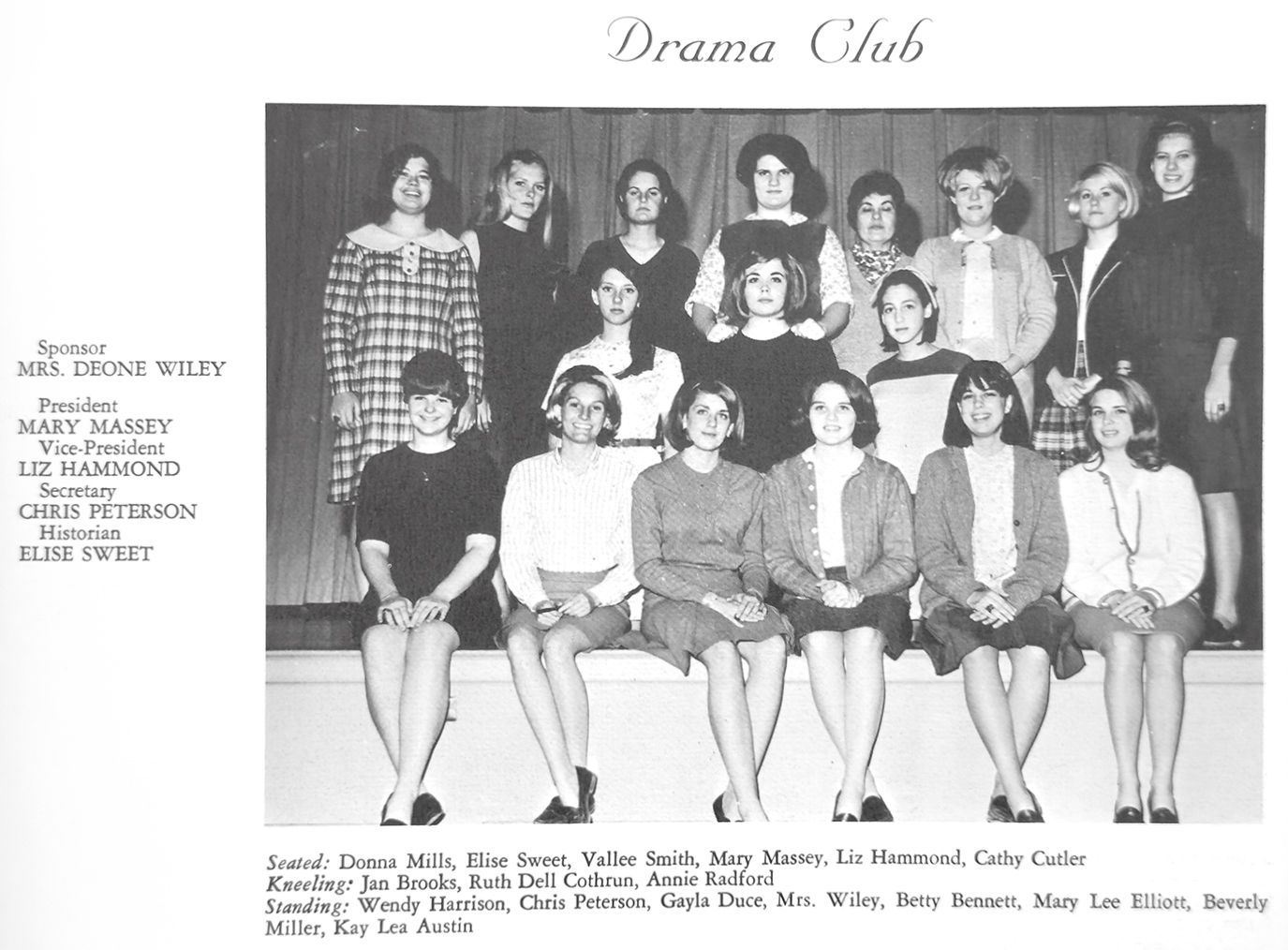 Drama Club group photo: students posing indoors, in front of a curtain.