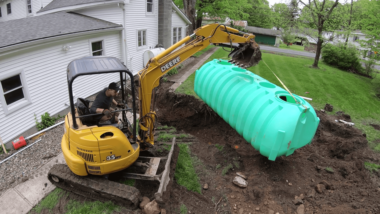 A new septic tank is being installed in the backyard of a residential property.