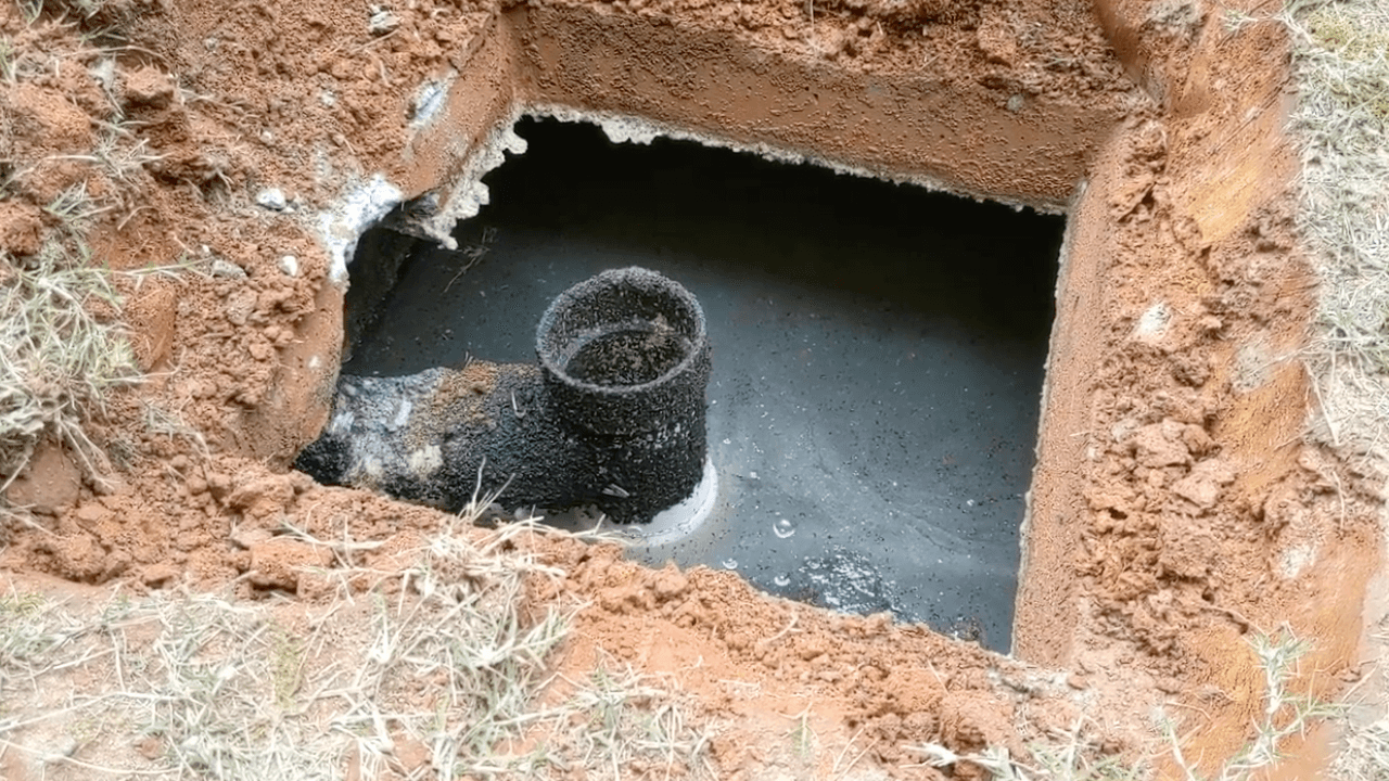 Septic tank professionals are performing a septic system inspection inservice for a potential homebuyer.