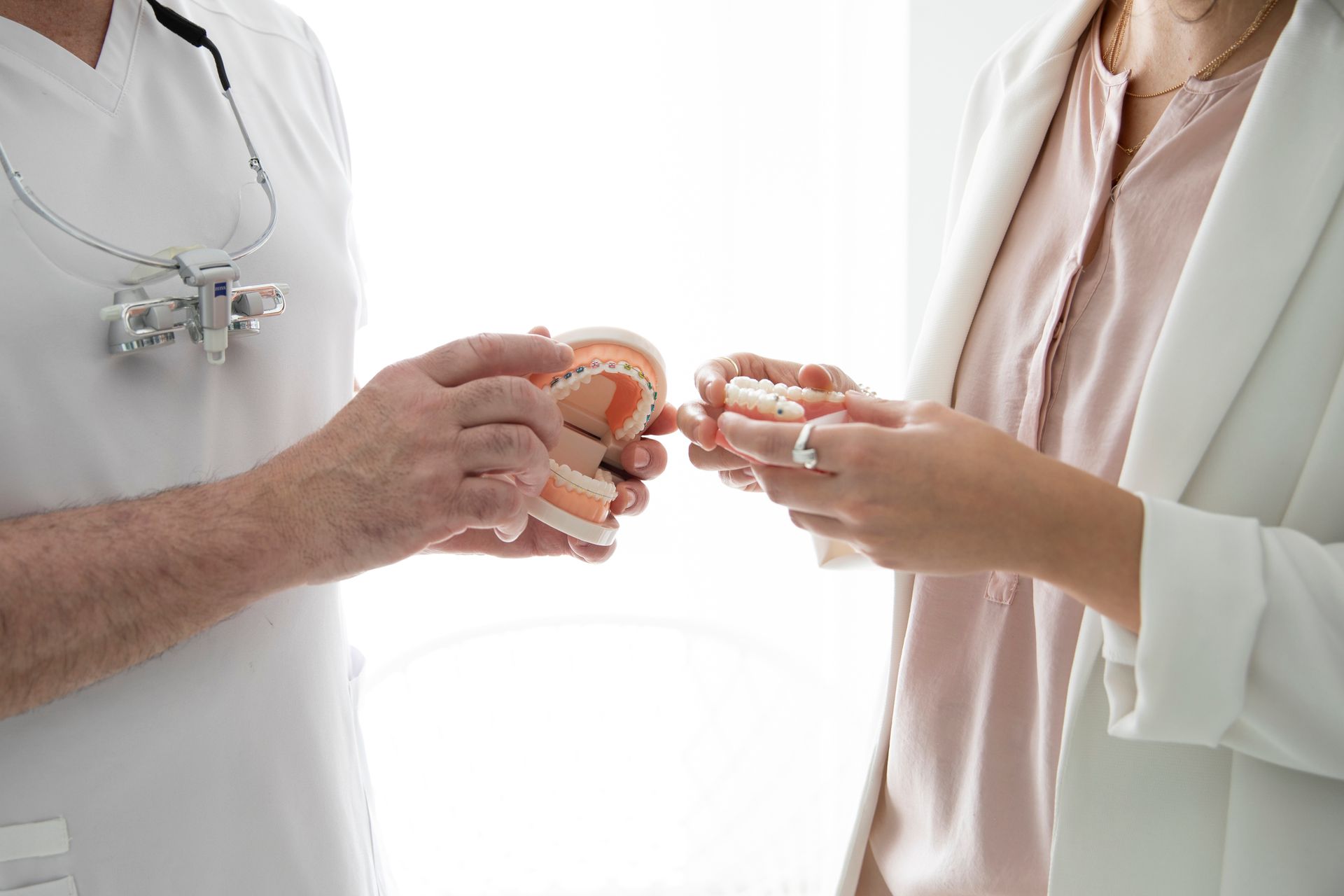 Dentist discussing cosmetic dentistry services like braces with a patient.
