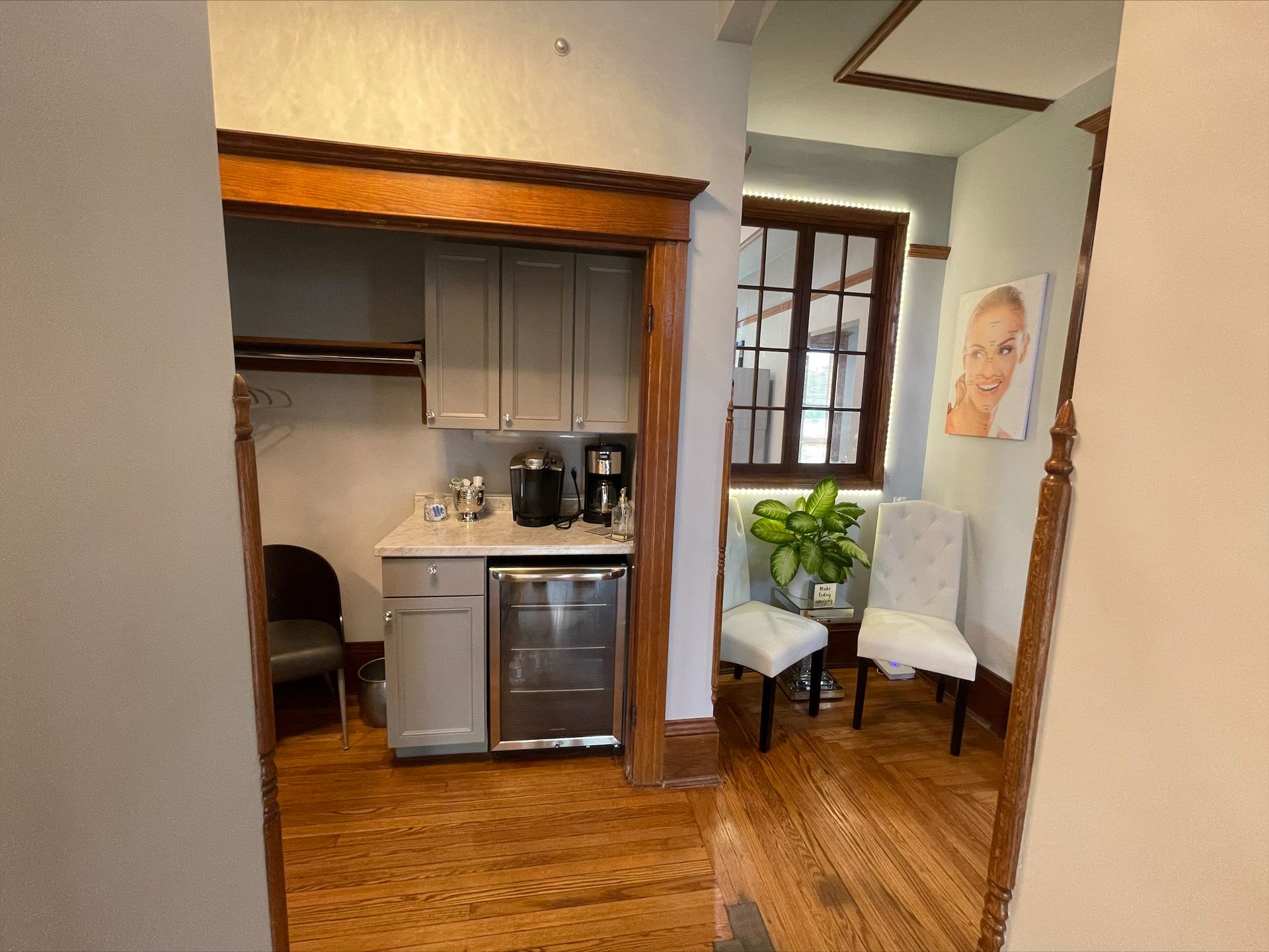 There is a picture of a woman on the wall in the waiting room.