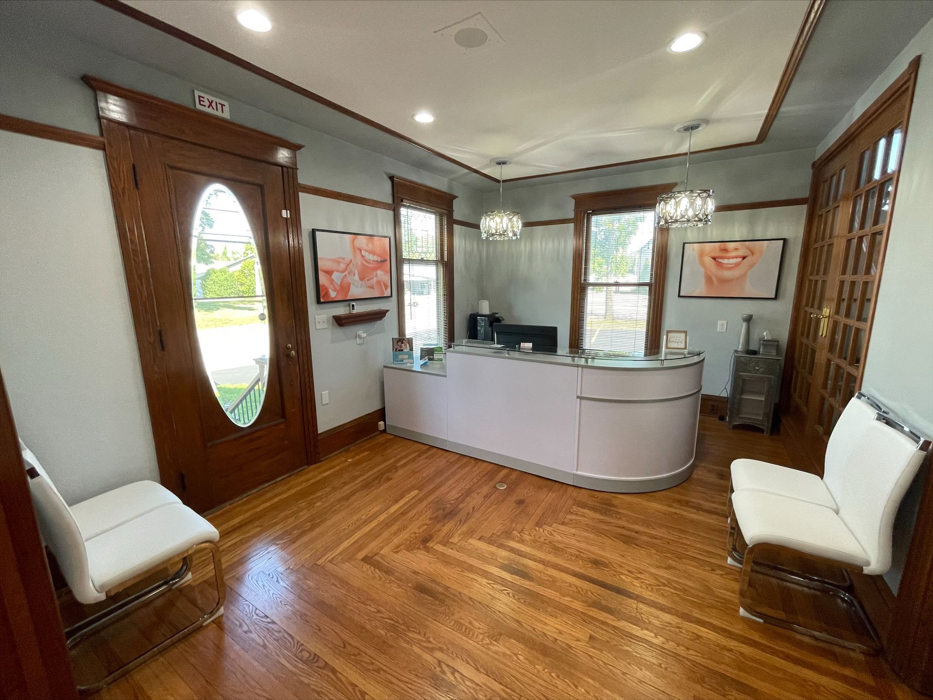A dental office with a reception desk and chairs.