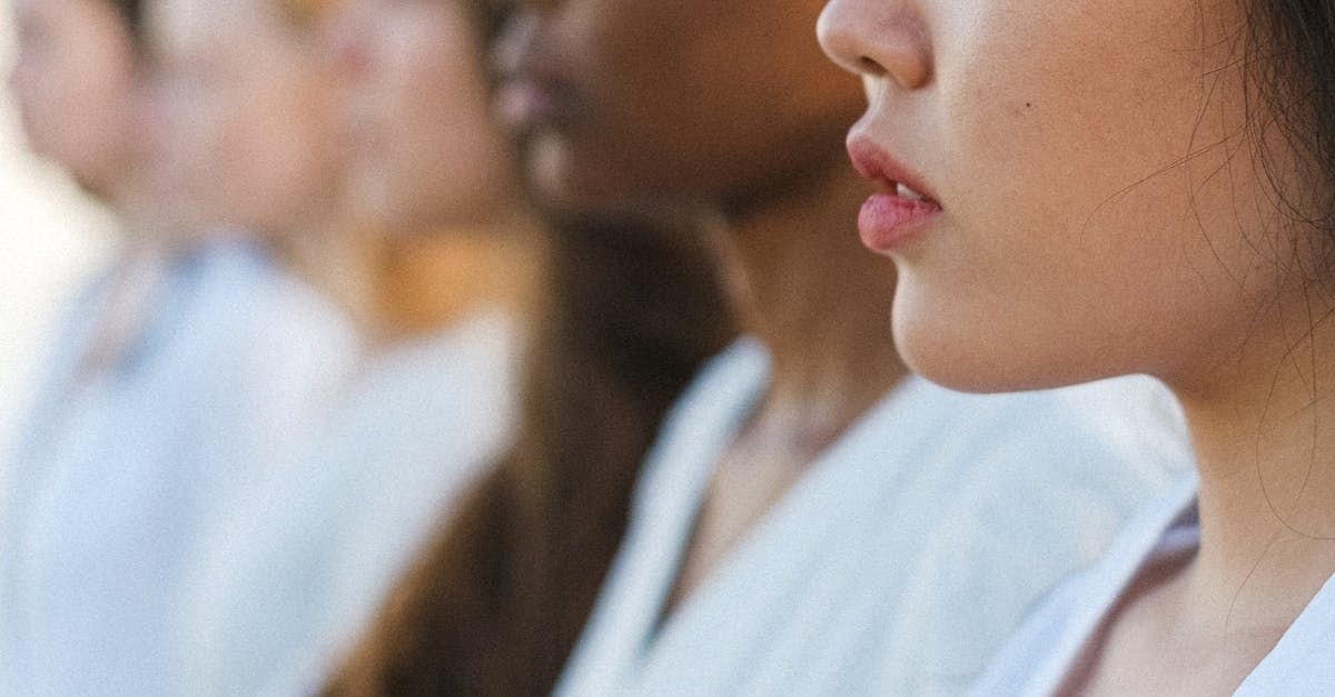 A person wearing a white t-shirt with the word