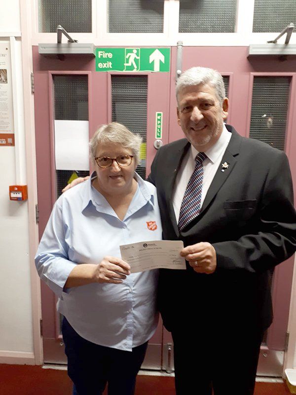 Worhsipful Master, Stephen Bull presents a cheque for £500 to the Salvation Army in Ware