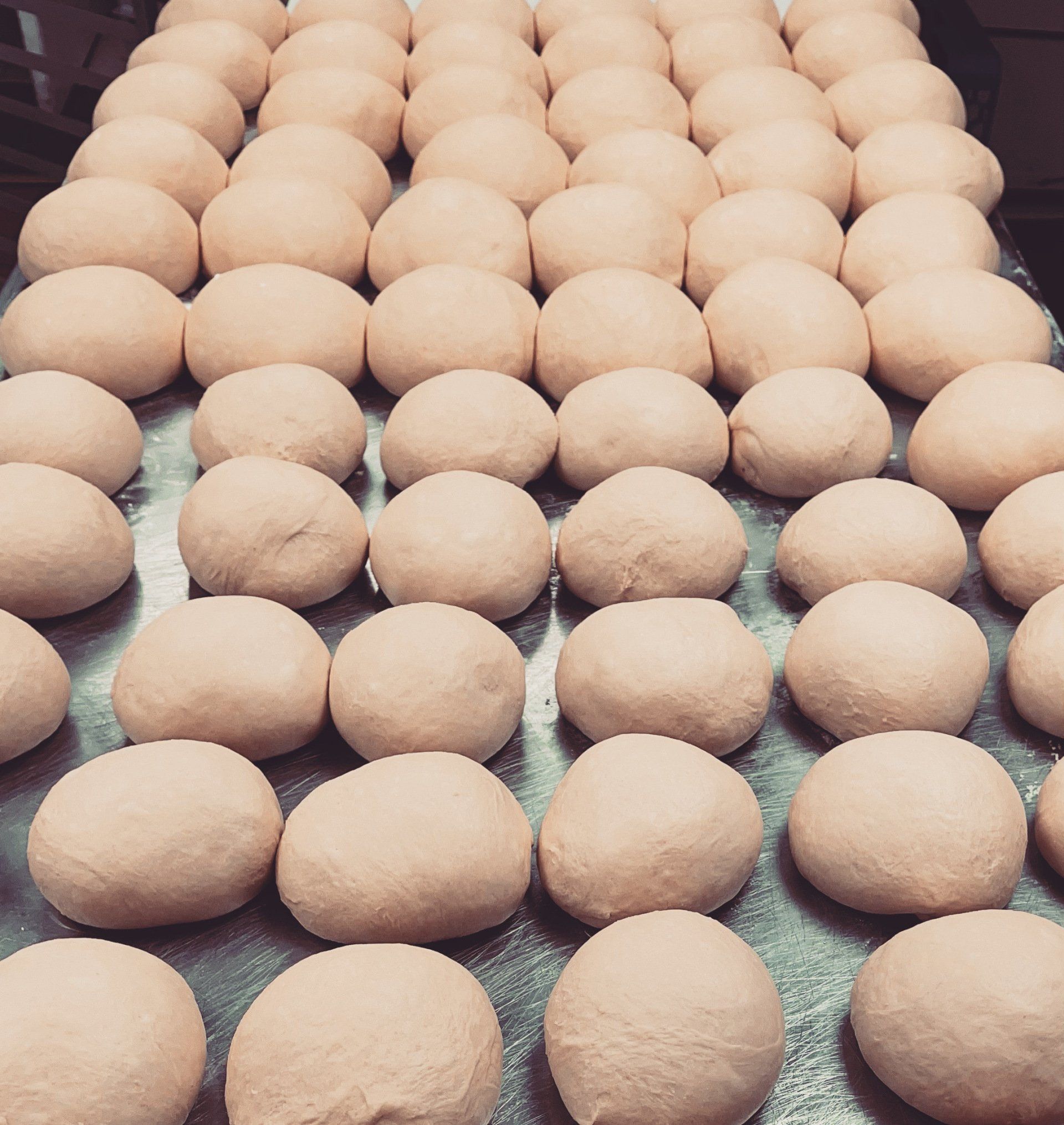 A bunch of balls of dough are sitting on a table