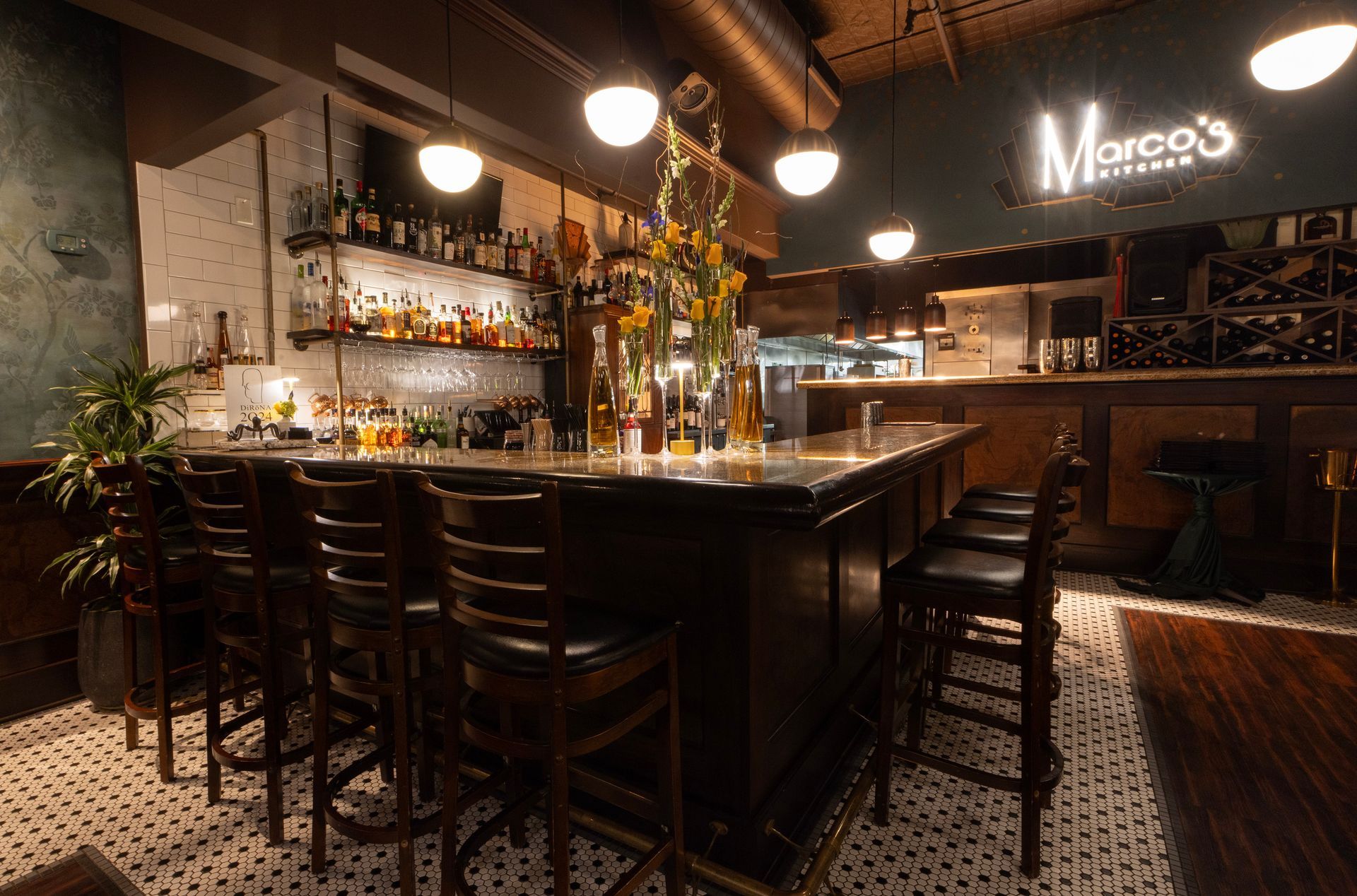 A restaurant with a long bar and lots of chairs