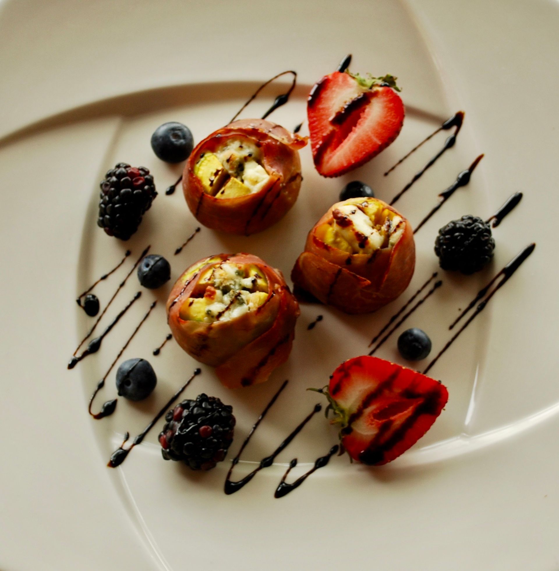 A plate of food with strawberries and blueberries on it