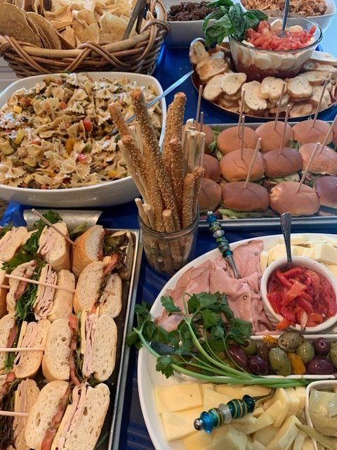 A table topped with a variety of food including sandwiches and appetizers