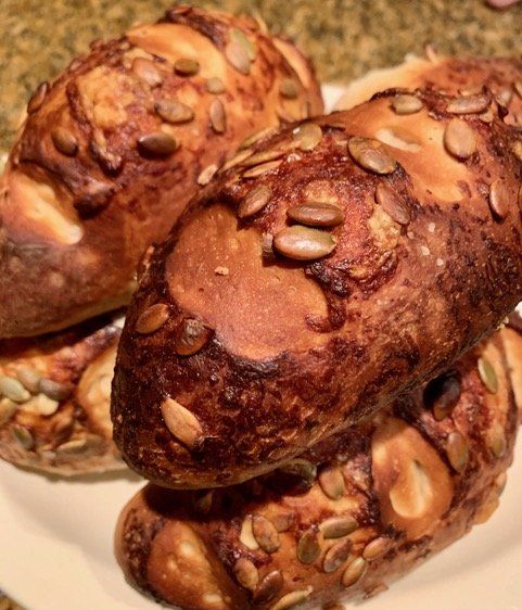 A plate of bread with pumpkin seeds on it