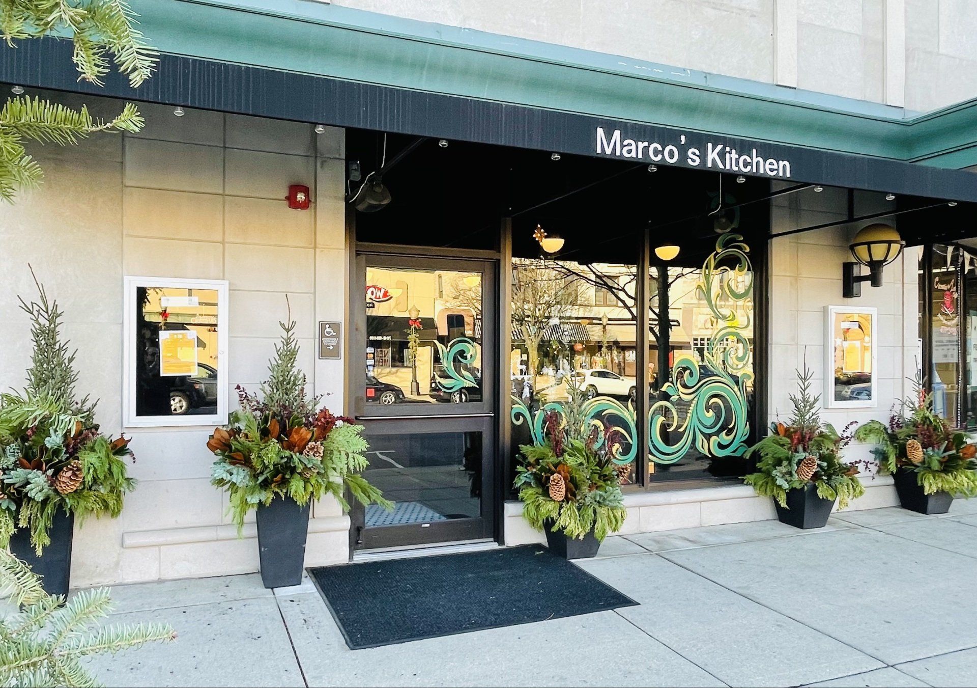 Marco 's kitchen has a green awning over the entrance