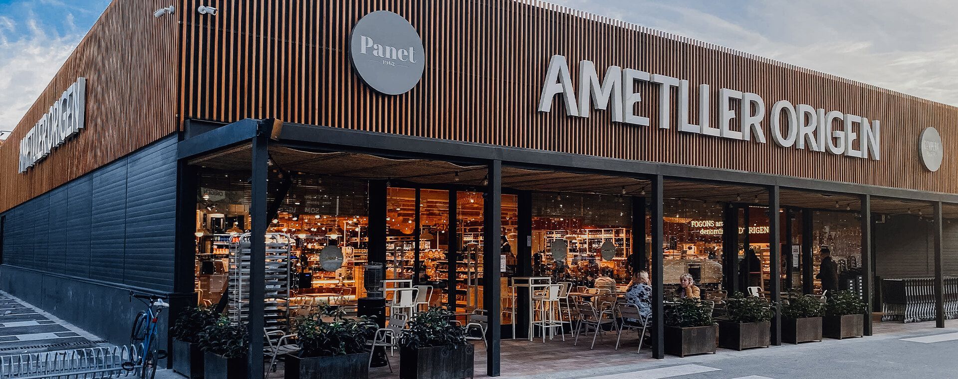 A large supermarket with a wooden facade and a lot of windows.