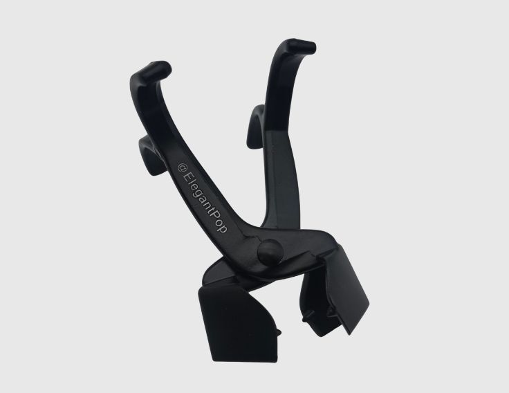 Black plastic device with handles and two angled gripping arms.