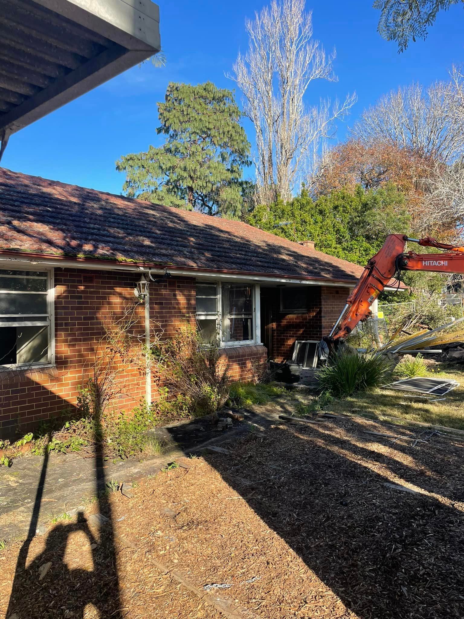 A brick house with a crane in front of it.