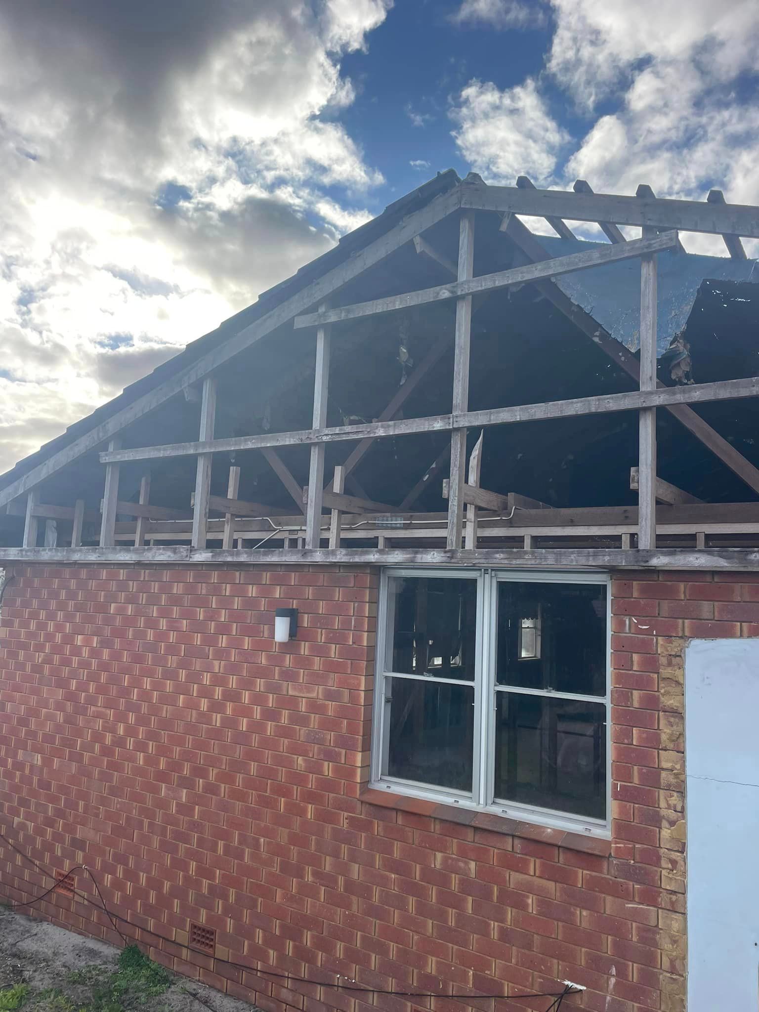 A brick building with a wooden roof and a window.