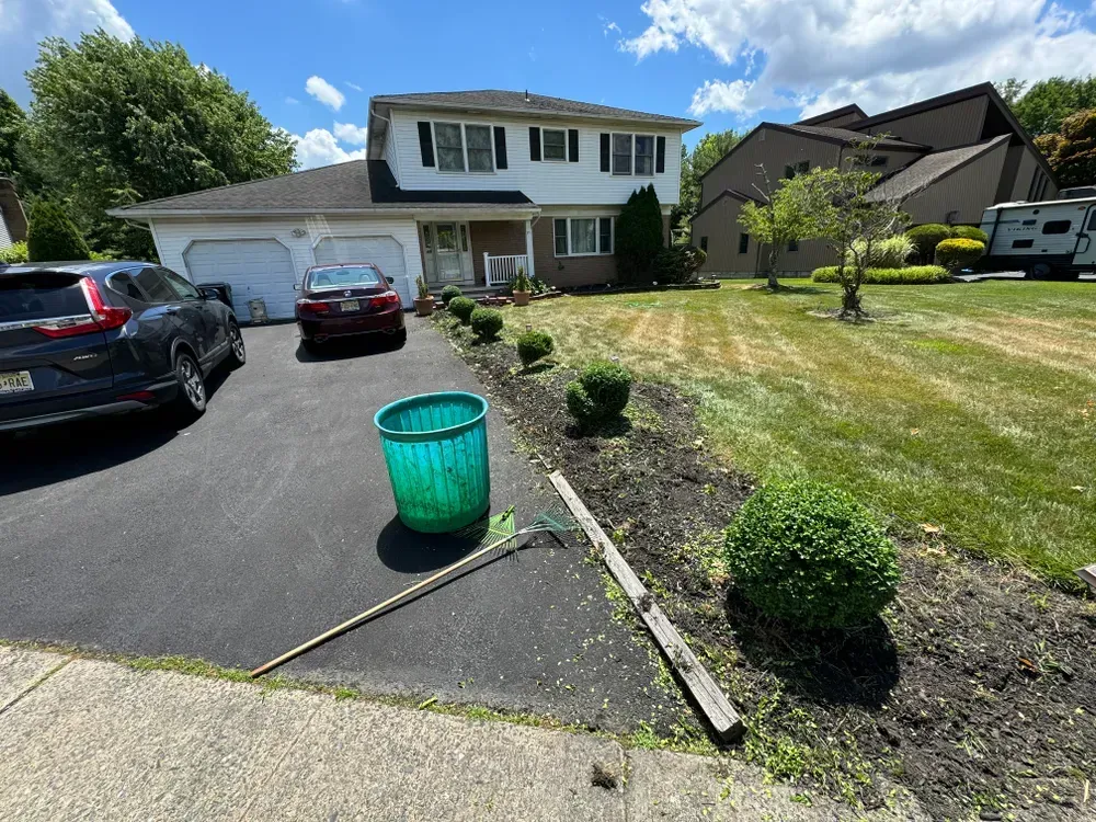 A car is parked in the driveway of a house.