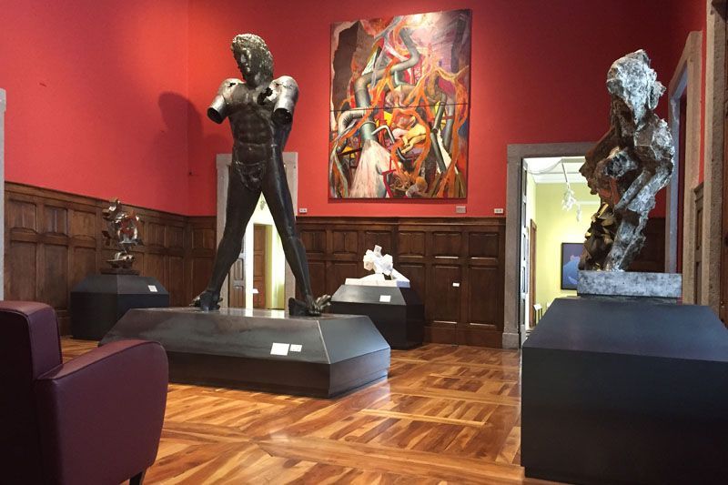 Visitors exploring a contemporary art exhibition inside Castello Gamba