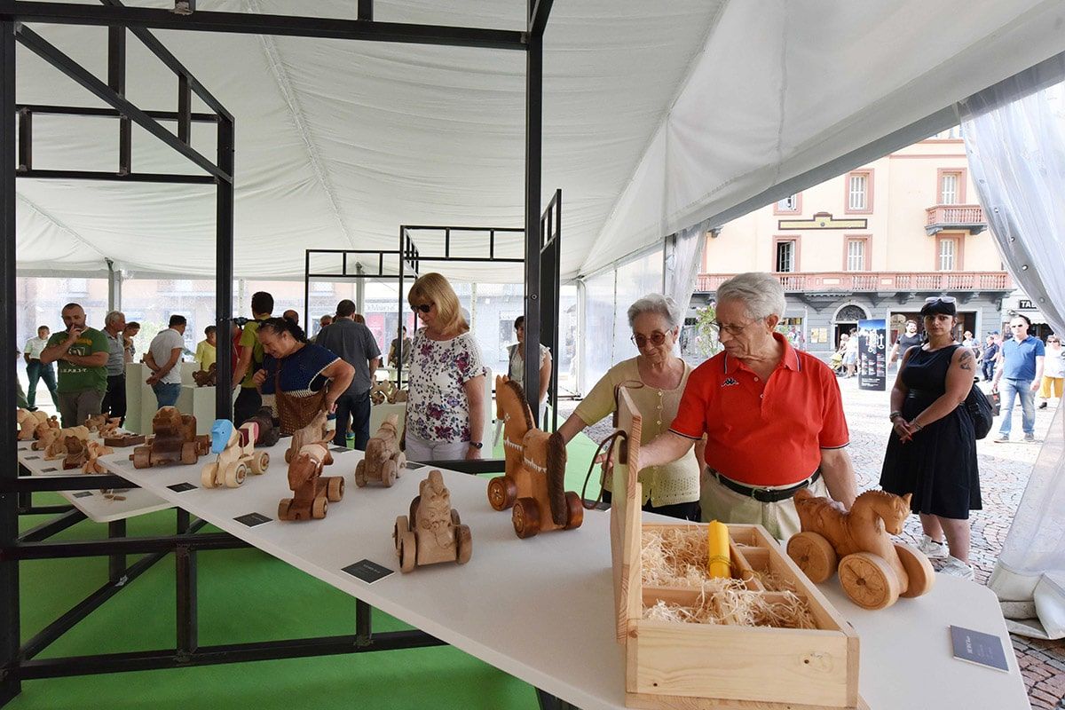 Artisan market in Aosta with traditional handmade crafts and visitors in the historic city centre