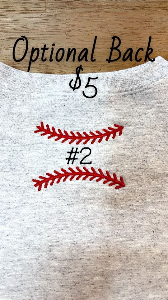 A close up of the back of a t-shirt with a baseball on it.