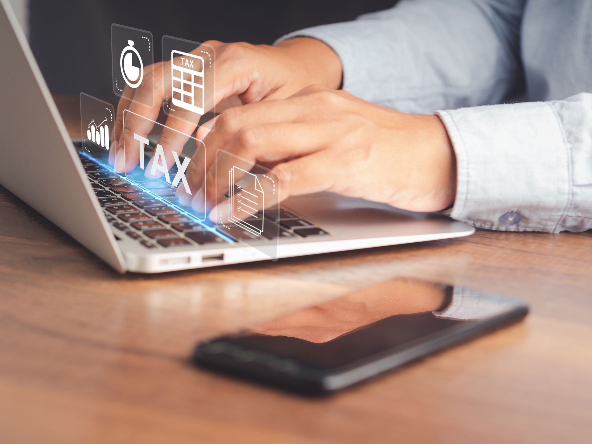 People reviewing business charts and graphs around a laptop in a meeting