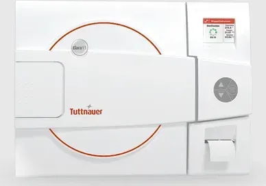 A white device with a red circle that says ' tuttnauer ' on it