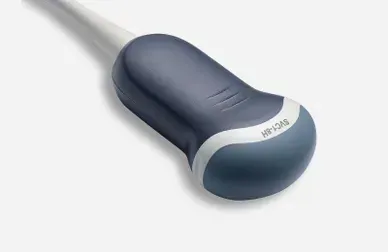 A blue and white ultrasound probe is sitting on a white surface.