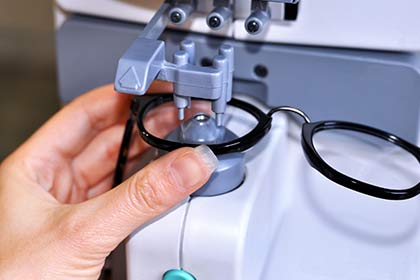 Lenses — Female Optician Measuring and Preparing Glasses in Fort Worth,  TX