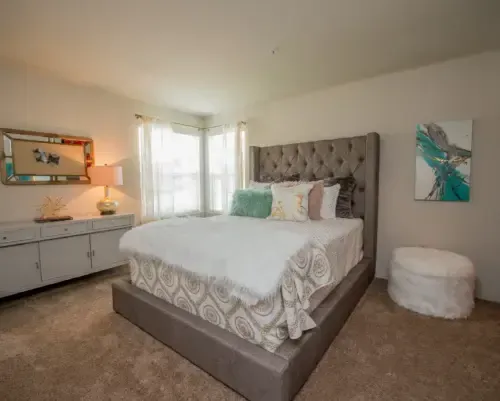 Well-decorated bedroom with a large bed and natural light