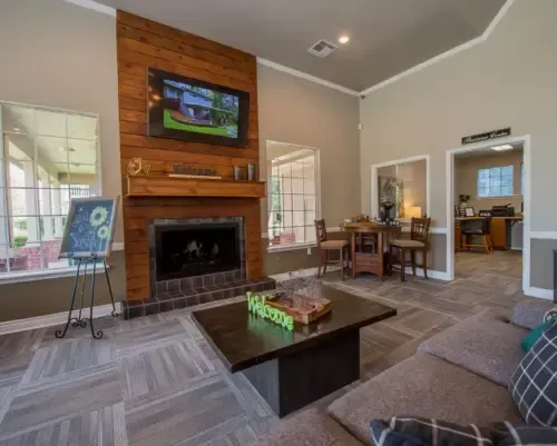 Common area featuring a fireplace, seating, and a TV.