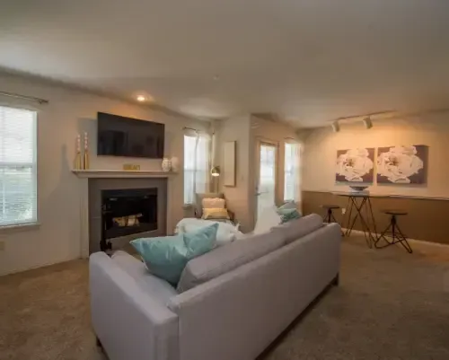 Cozy living room with a sofa, fireplace, and artwork