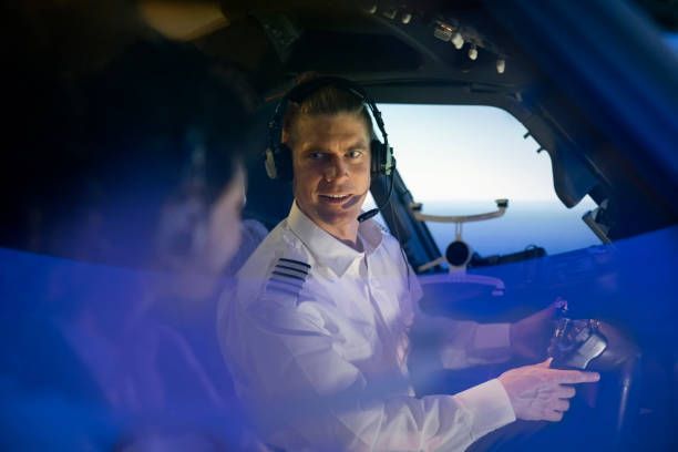 Pilot instructing trainee in simulator, showcasing FAA medical exam readiness and aviation safety.