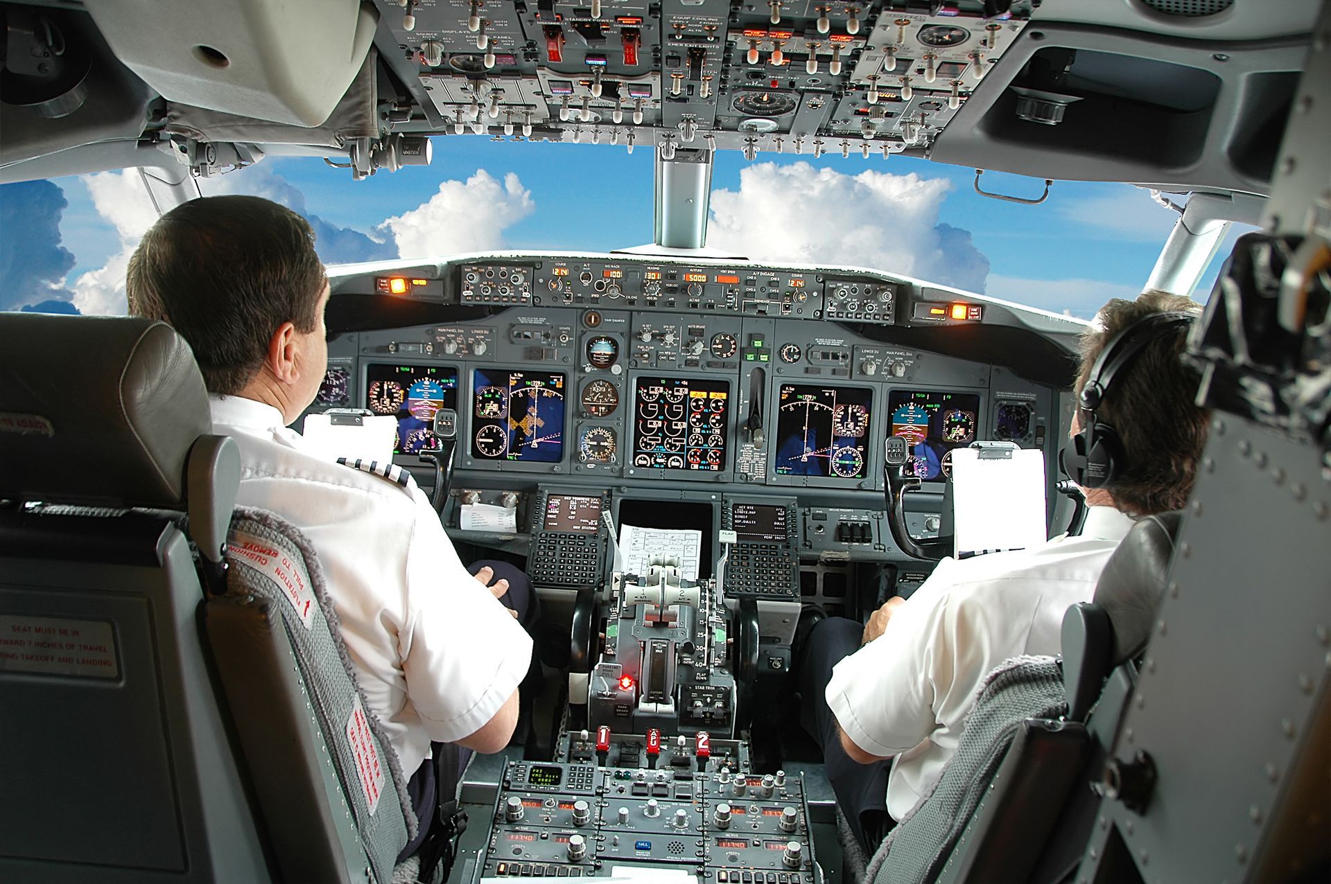Two pilots in cockpit showcasing FAA medical exam importance for professional flight crews.