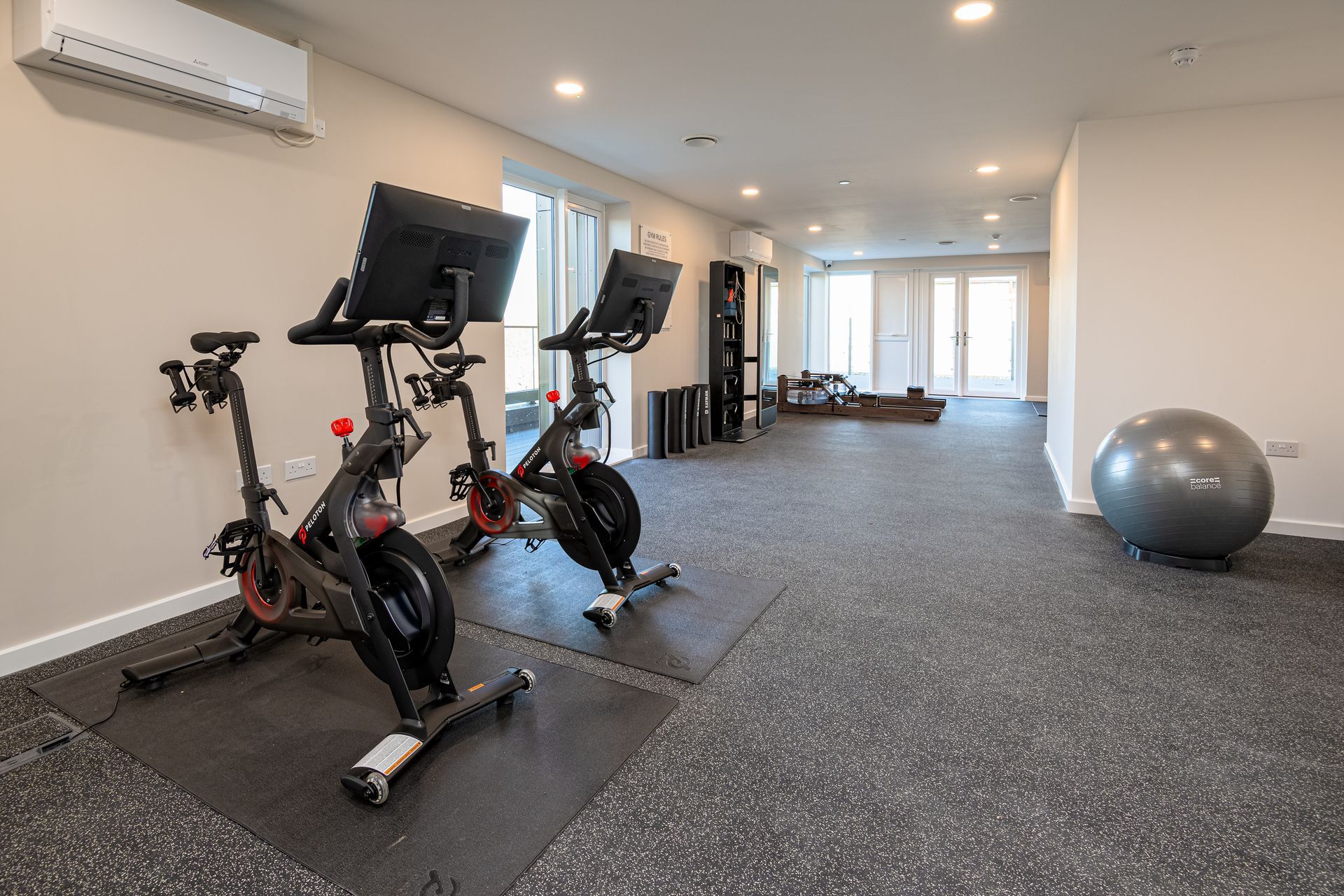 A gym with two exercise bikes and a pilates ball at Walton Court.
