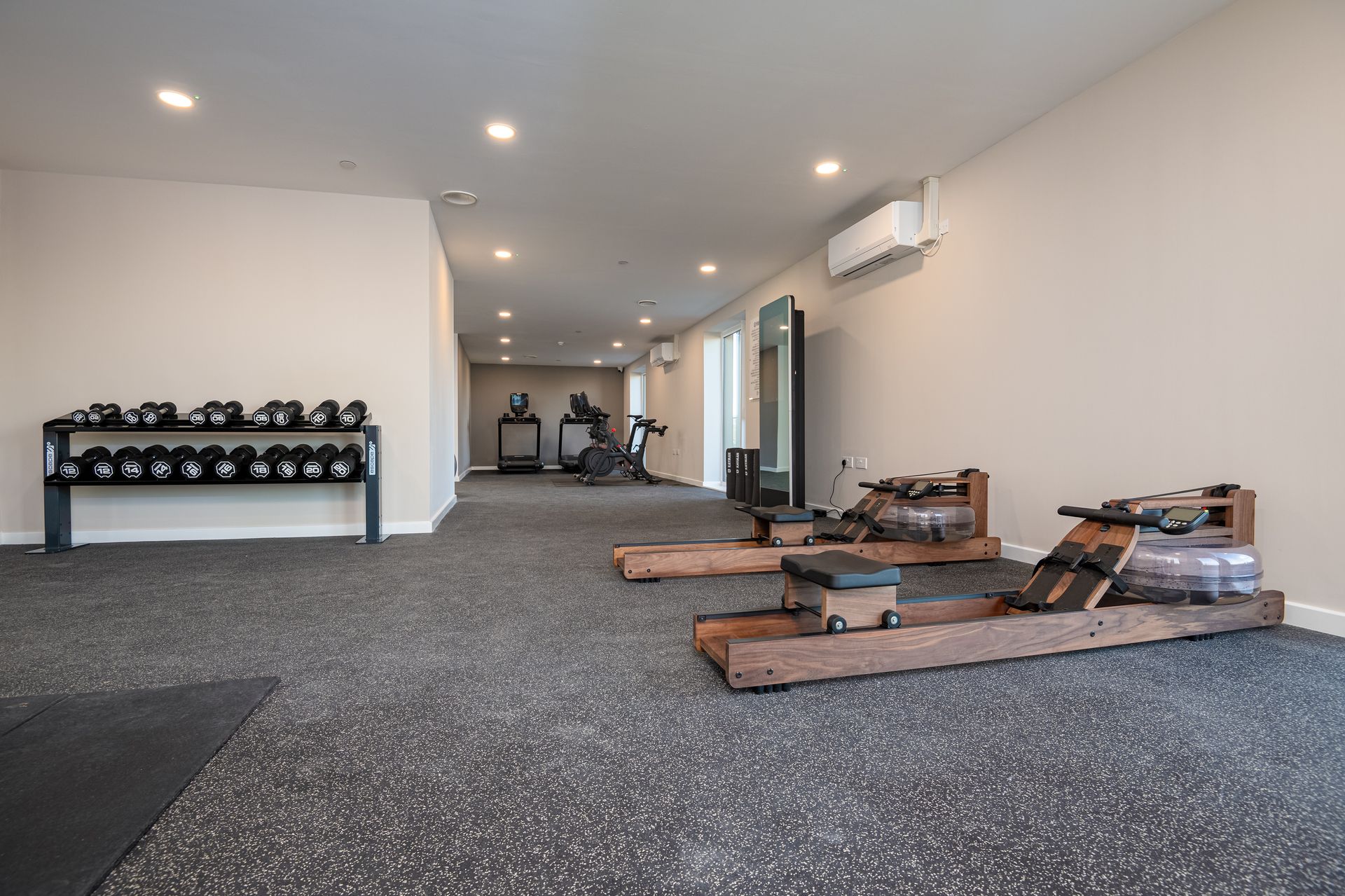 A large room with a lot of exercise equipment in it at Walton Court.