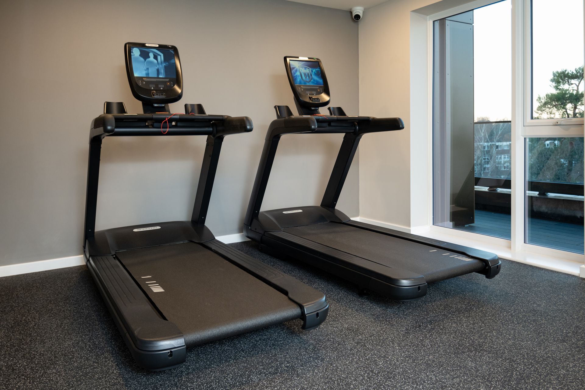 Two treadmills are sitting next to each other in a gym at Walton Court.